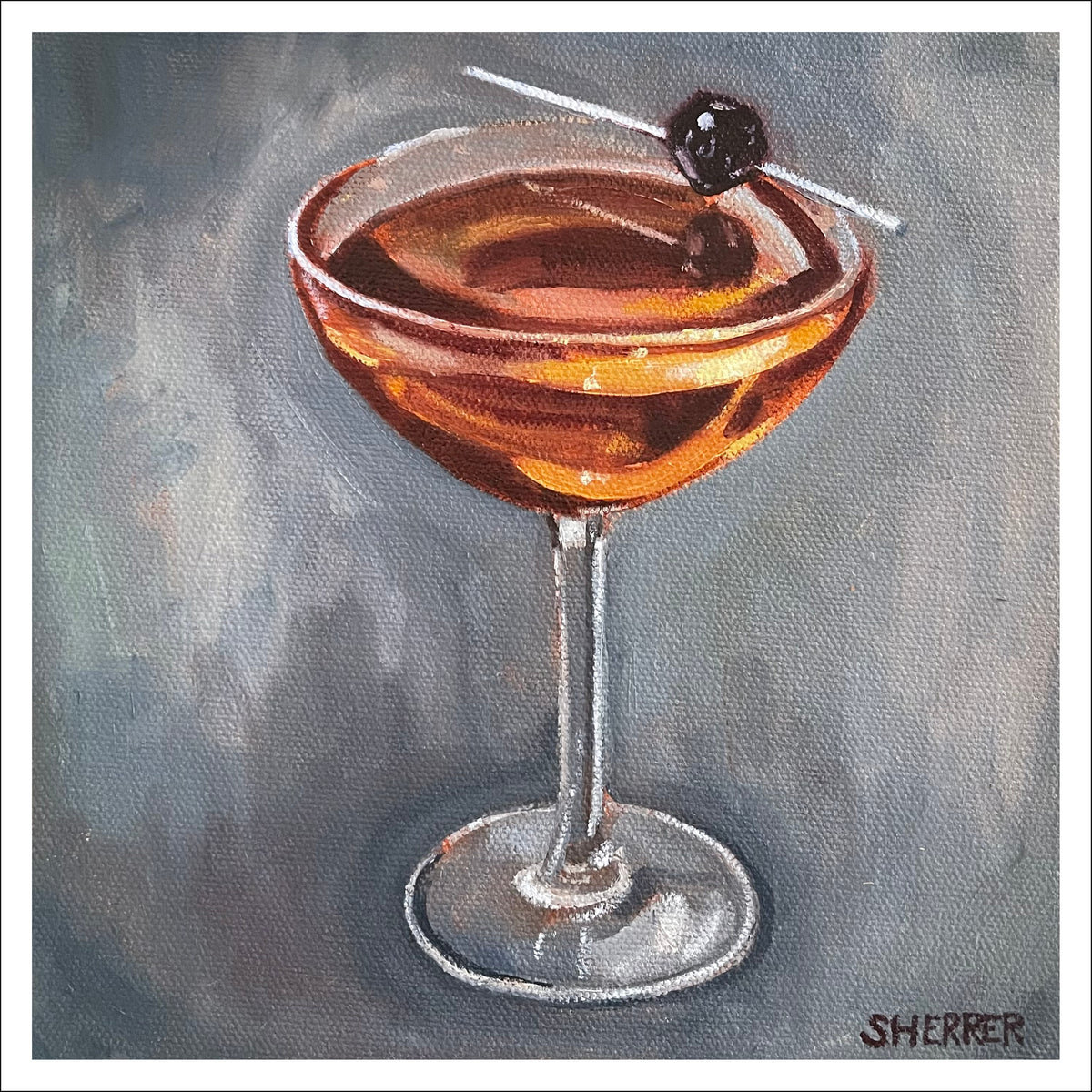 Manhattan Drink fine art print by Caroline Sherrer, featuring a classic Manhattan cocktail sitting on a gently textured navy blue background.