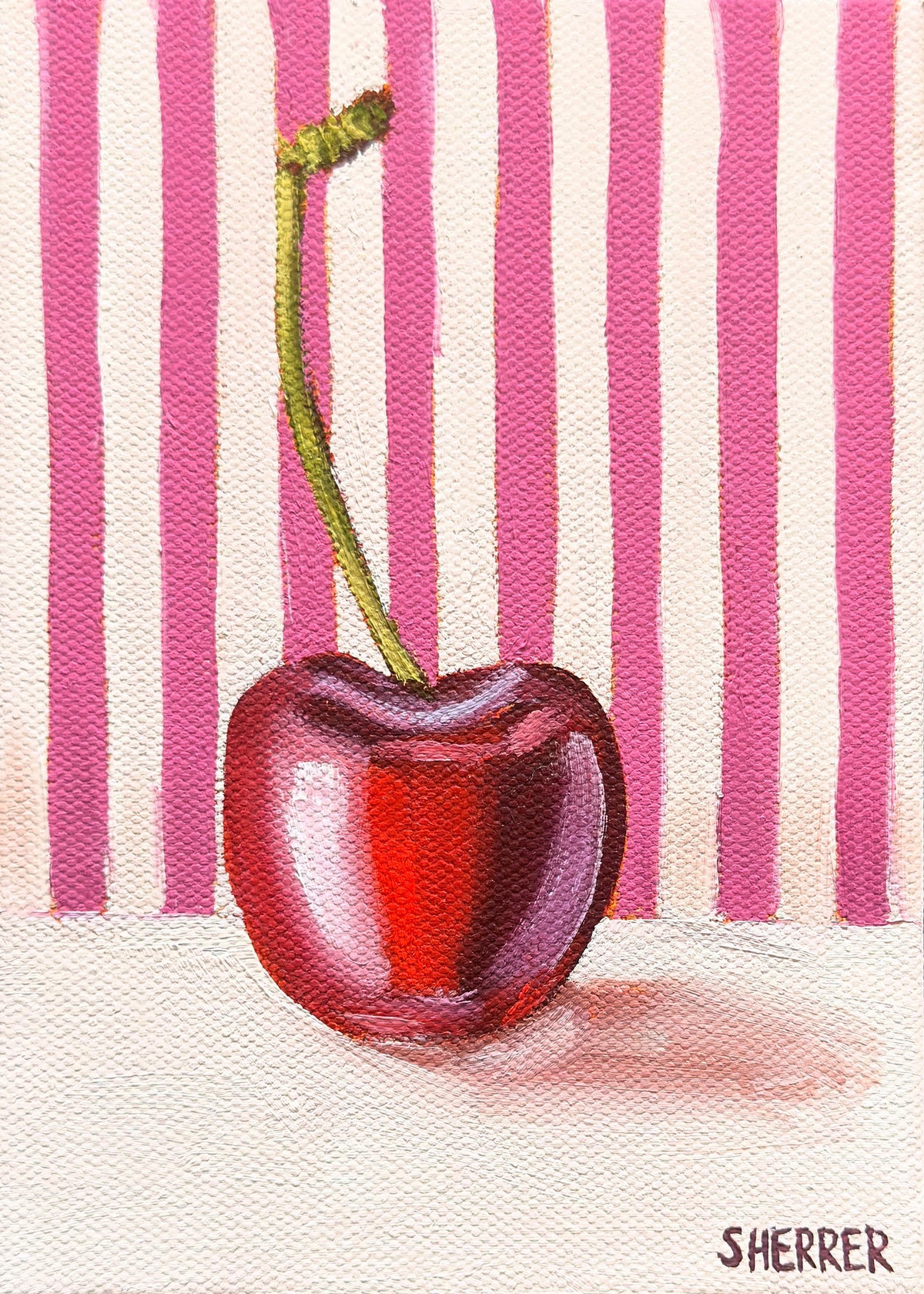 Pink Repeat, original oil painting by Caroline Sherrer, featuring a single cherry resting on a background where the upper two thirds is pink and white stripes and the bottom one third is a whiteish tan.