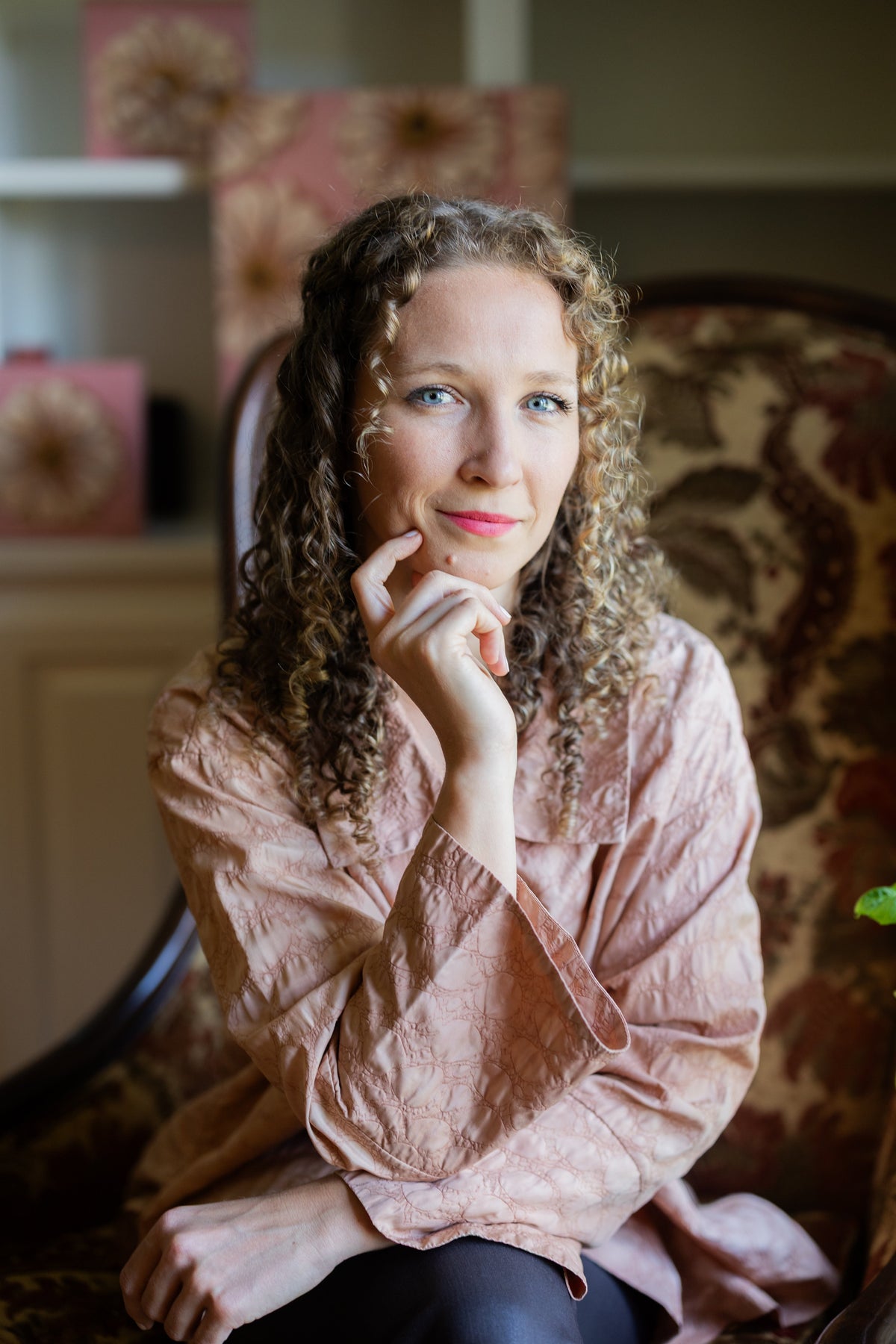 Caroline Sherrer seated in an ornate chair, wearing a pink blouse.