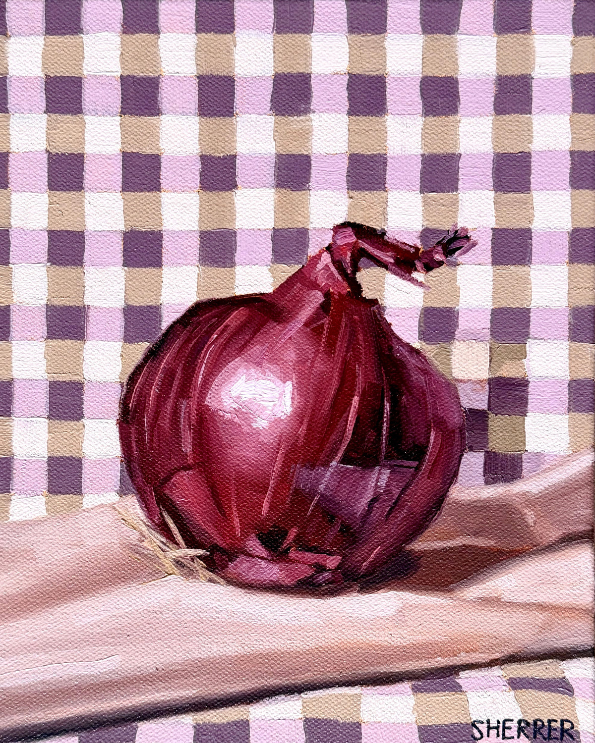 Red Onion on Gingham, original oil painting by Caroline Sherrer, featuring a red onion resting on a purple, mauve and white gingham napkin. The onion and napkin rest on a mauve background.