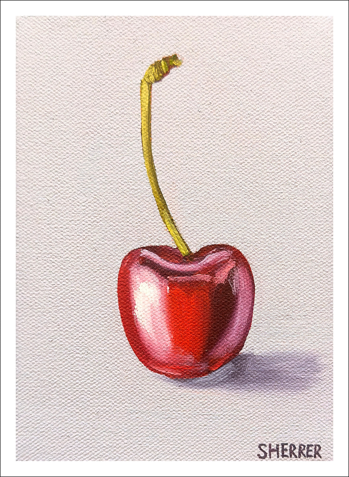 Cherry on Muted Blue Background fine art print by Caroline Sherrer, featuring a single red cherry resting on a pale muted-blue background. 