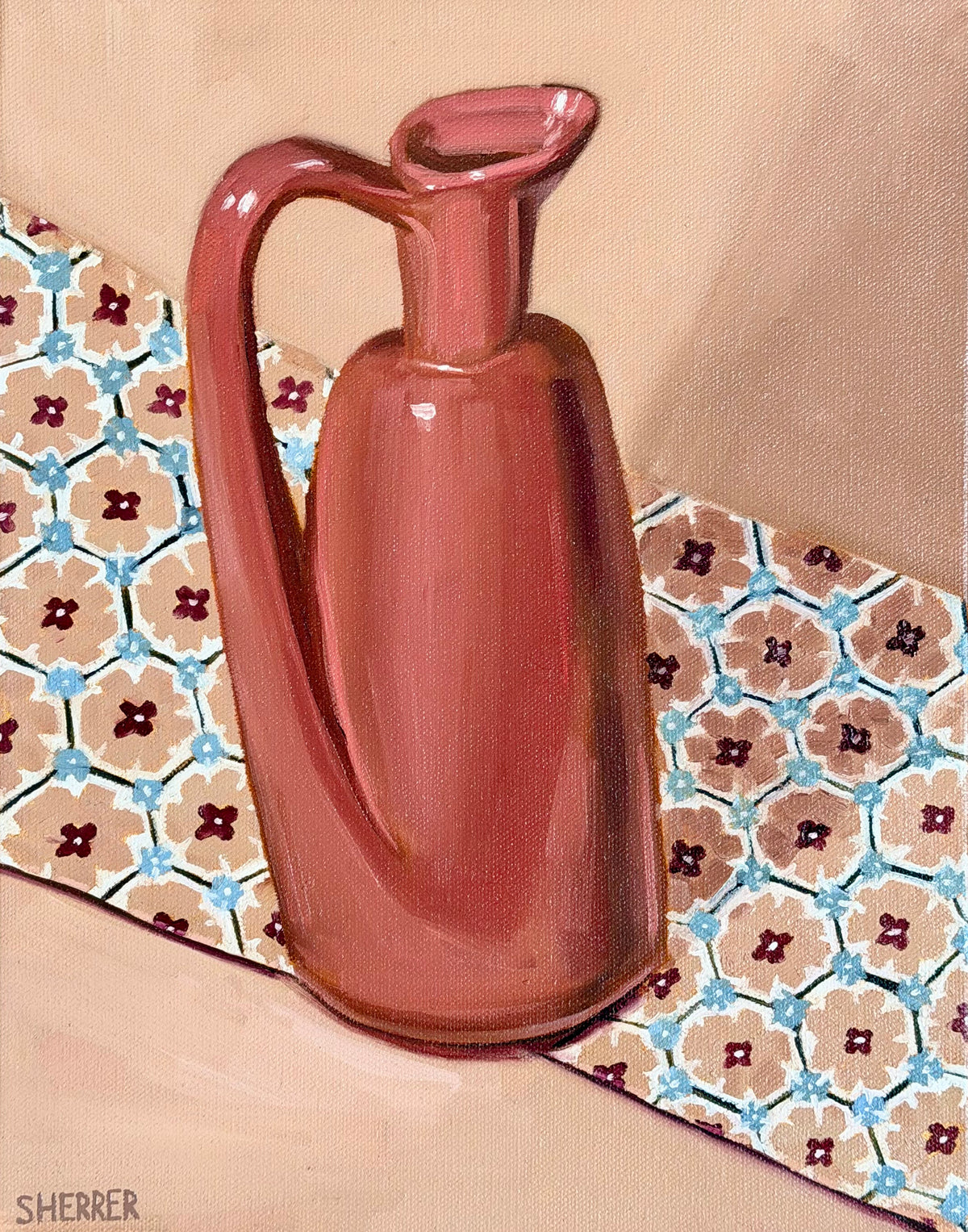 Pink Vessel, original oil painting by Caroline Sherrer, featuring a tall, narrow pink ceramic vase with a handle. The vase sits on a piece of fabric with a white, blue and pink geometric pattern. The vase and fabric sit on a mauve background.